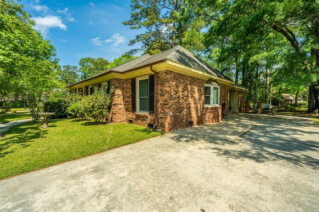 view of side of home featuring a lawn