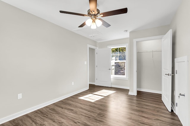 unfurnished bedroom with ceiling fan, a closet, and dark wood-type flooring