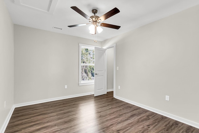 spare room featuring ceiling fan and dark wood-type flooring