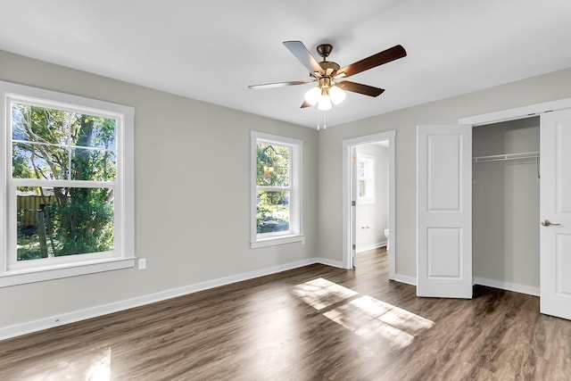2711 Henry St, North Charleston, SC 29405 - unfurnished bedroom featuring multiple windows, a closet, wood finished floors, and baseboards