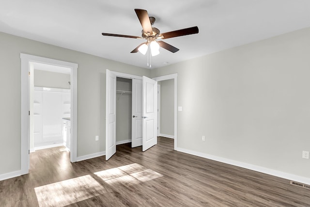 2711 Henry St, North Charleston, SC 29405 - unfurnished bedroom with wood finished floors, baseboards, a closet, a ceiling fan, and ensuite bath