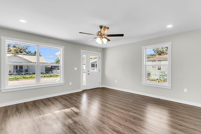 interior space with ceiling fan and dark hardwood / wood-style flooring