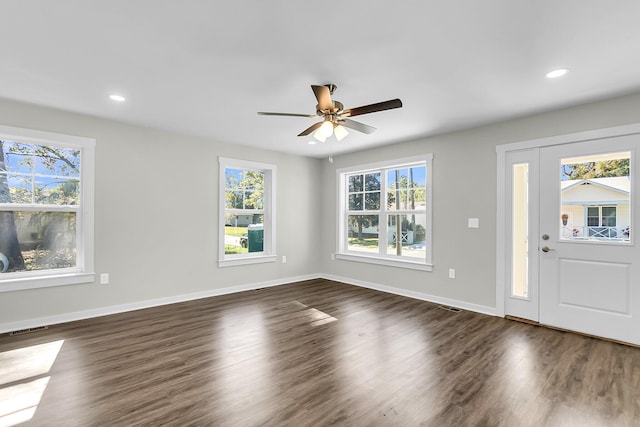 foyer entrance featuring ceiling fan, plenty of natural light, and dark hardwood / wood-style floors