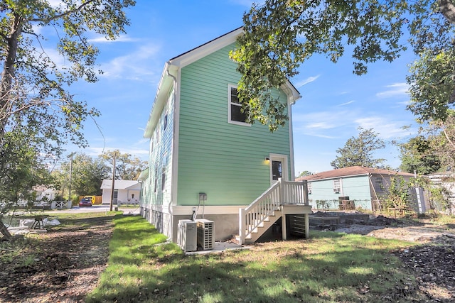 view of side of home with central AC