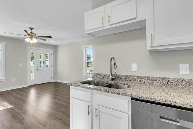 kitchen featuring light stone countertops, dishwasher, sink, dark wood-type flooring, and white cabinets