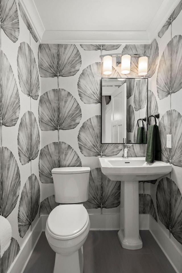 bathroom with crown molding and toilet