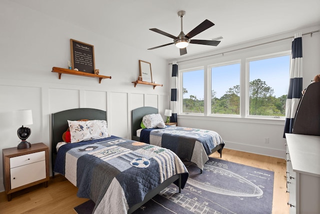 bedroom with wood-type flooring and ceiling fan