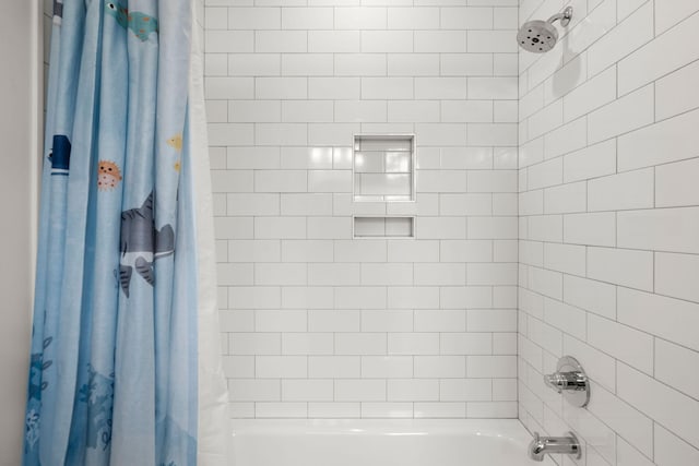 bathroom with shower / bathtub combination with curtain