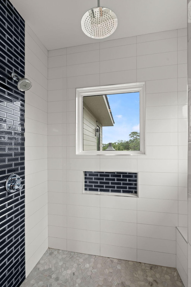 bathroom with a tile shower