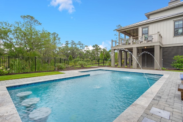 view of swimming pool featuring pool water feature and a wooden deck