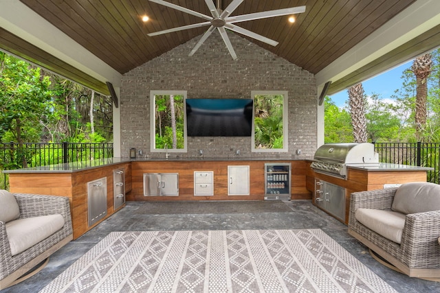 view of patio / terrace with sink, area for grilling, wine cooler, and ceiling fan