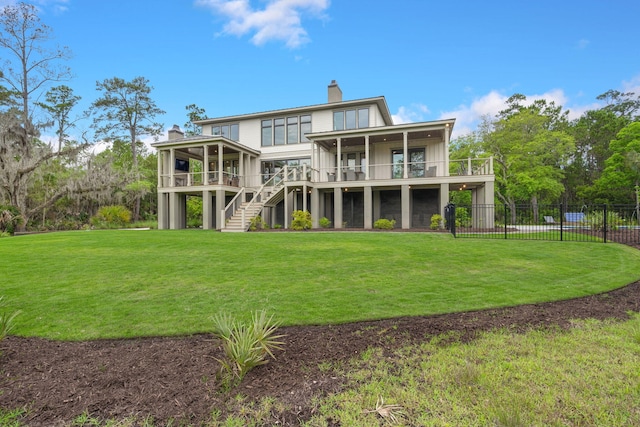 rear view of house featuring a lawn