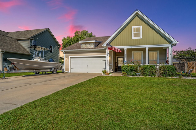 craftsman-style home featuring a lawn, a porch, and a garage