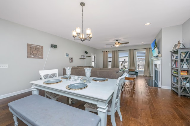 513 Abigail St, Moncks Corner, SC 29461 - dining area featuring a fireplace, wood-type flooring, ceiling fan with notable chandelier, and baseboards