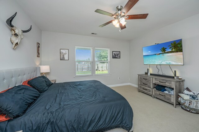 bedroom with ceiling fan and light colored carpet