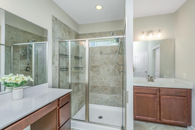 bathroom with tile patterned floors, an enclosed shower, and vanity