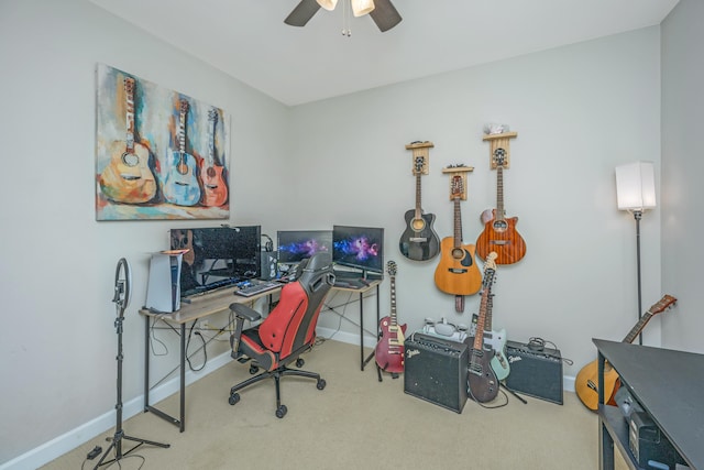 carpeted home office featuring ceiling fan