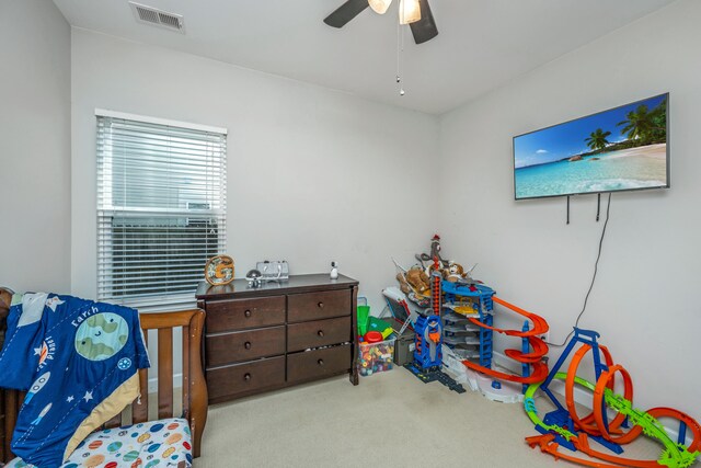 interior space with light carpet and ceiling fan