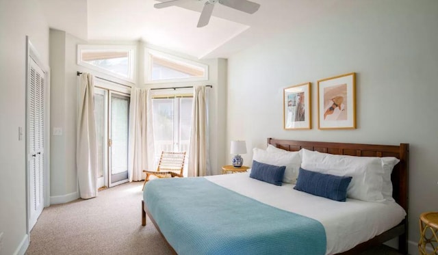 carpeted bedroom featuring ceiling fan, high vaulted ceiling, and a closet