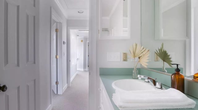 bathroom featuring vanity and ornamental molding