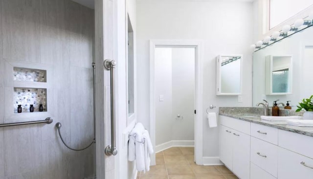 bathroom featuring tile patterned flooring and vanity