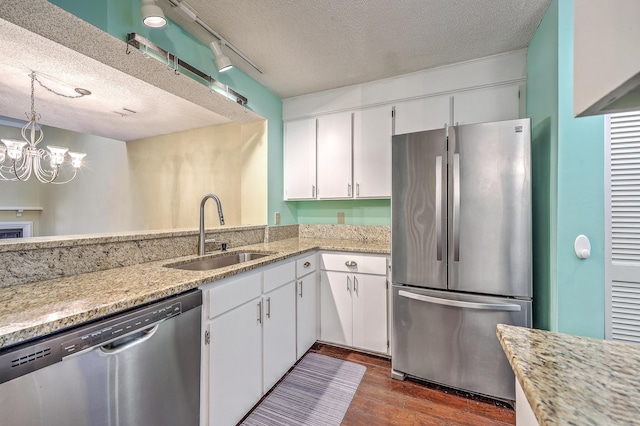 1115 Shadow Lake Cir, Mount Pleasant, SC 29464 - kitchen with appliances with stainless steel finishes, a sink, a textured ceiling, dark wood-style flooring, and white cabinetry
