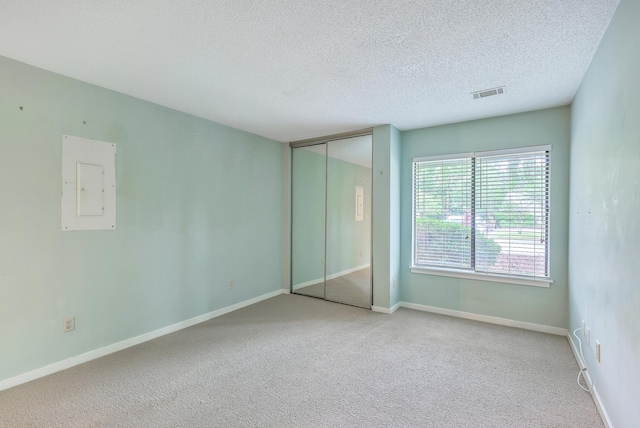 1115 Shadow Lake Cir, Mount Pleasant, SC 29464 - unfurnished bedroom featuring carpet flooring, a textured ceiling, electric panel, a closet, and baseboards