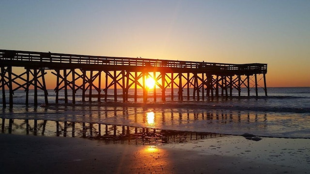 view of dock with a beach view, a pier, and a water view