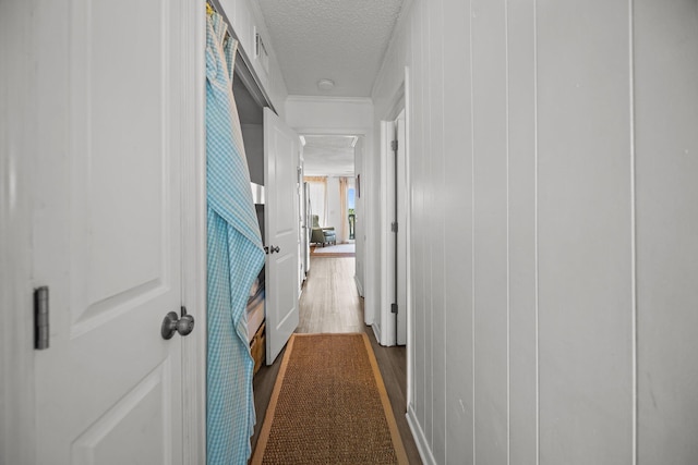 hallway featuring dark wood-style flooring and a textured ceiling
