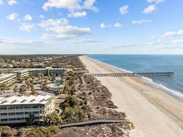 birds eye view of property featuring a beach view and a water view