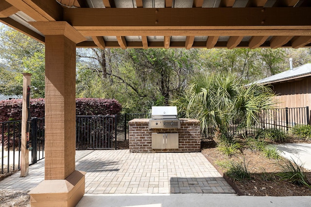 view of patio / terrace featuring area for grilling, a grill, and fence