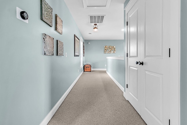 hallway featuring baseboards and carpet flooring