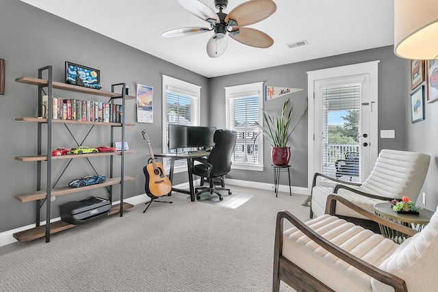 office with a ceiling fan, baseboards, healthy amount of natural light, and carpet