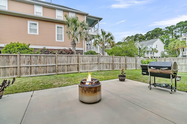 view of patio with a fire pit, grilling area, and a balcony