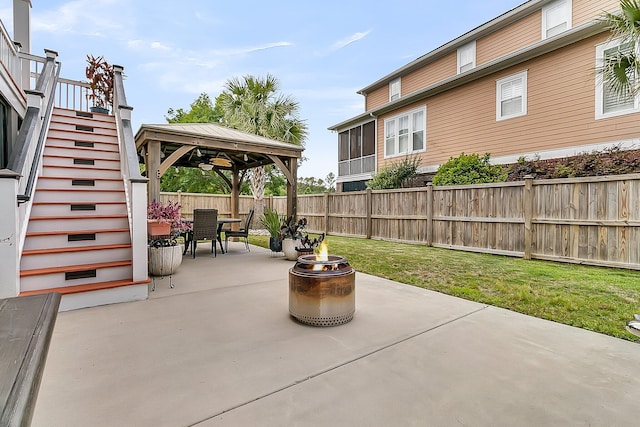 view of patio featuring a gazebo, a fire pit, outdoor dining space, and stairs