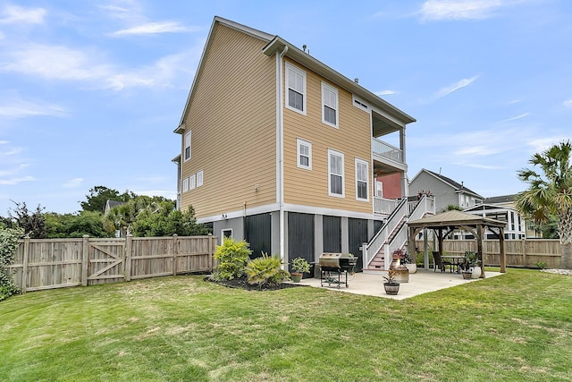 back of house with a gazebo, a patio, stairs, a gate, and a balcony