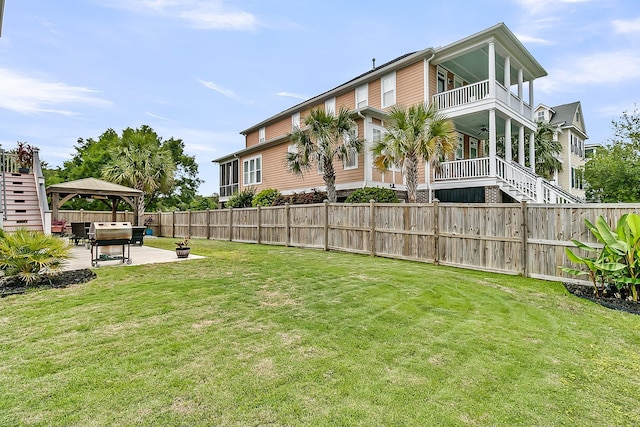 view of yard with a gazebo, stairs, a patio area, and a balcony