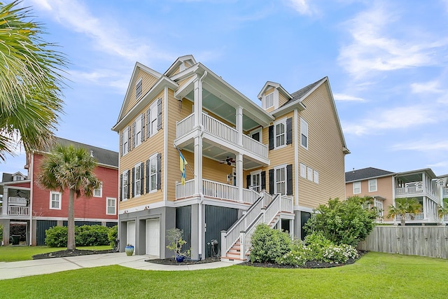 view of property with stairway, an attached garage, fence, and driveway