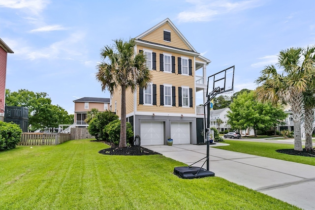 beach home with an attached garage, driveway, and a front yard