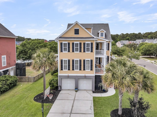 beach home featuring an attached garage, driveway, and a shingled roof