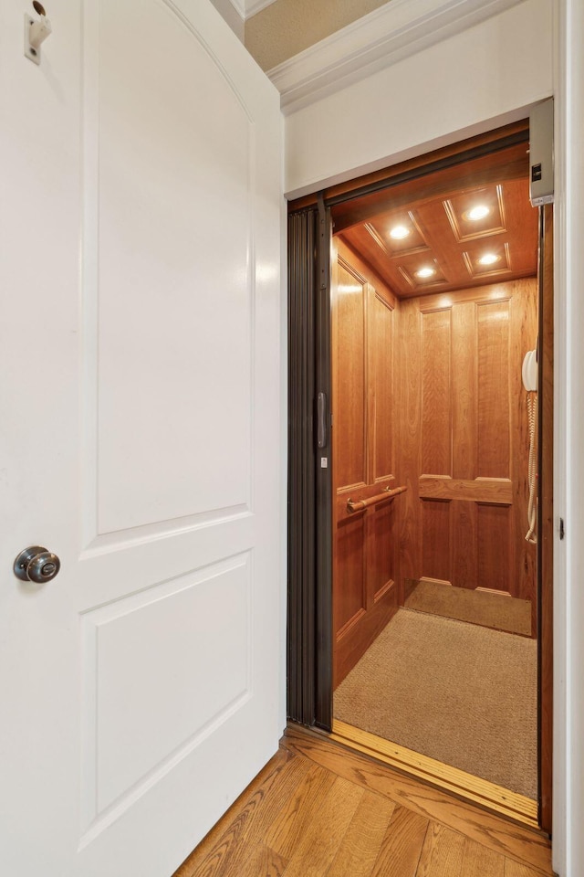 room details featuring elevator and wood finished floors