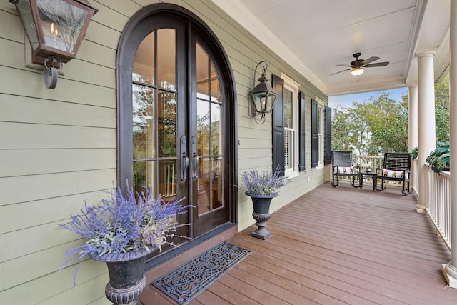 wooden deck featuring covered porch and ceiling fan