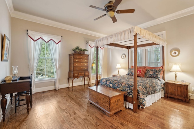 bedroom featuring ornamental molding, wood finished floors, and baseboards