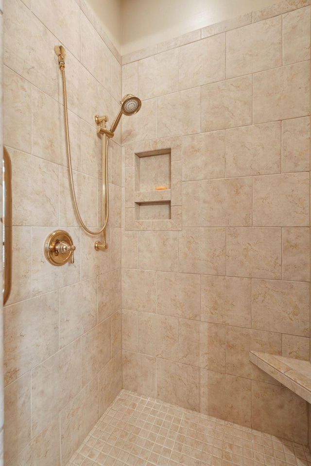 bathroom with a tile shower