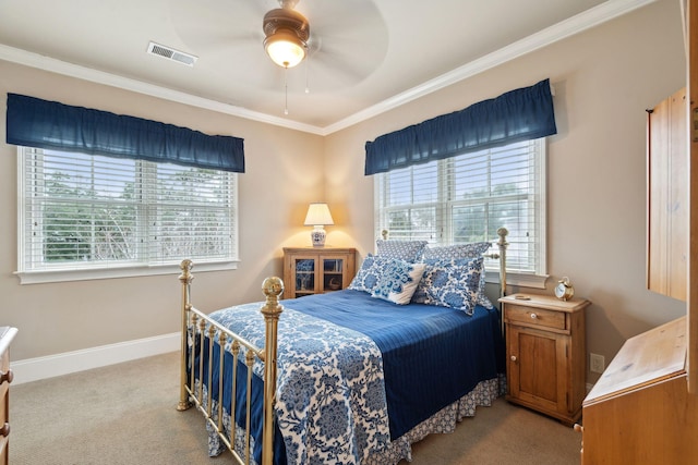 bedroom featuring baseboards, visible vents, light colored carpet, ceiling fan, and crown molding