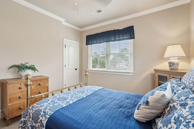 carpeted bedroom with visible vents and crown molding