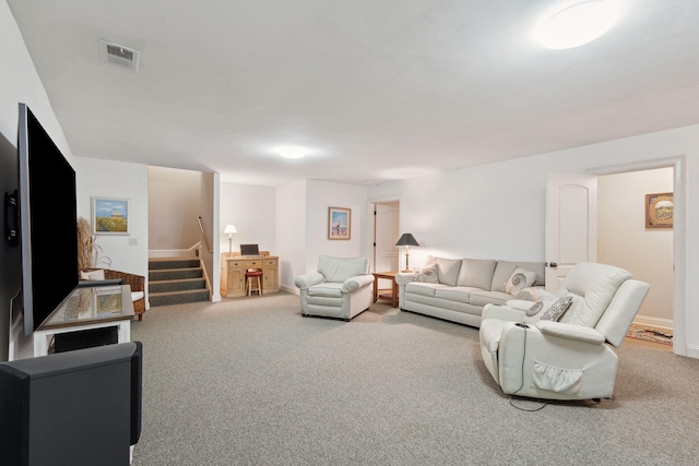 living area featuring carpet floors, stairs, and visible vents