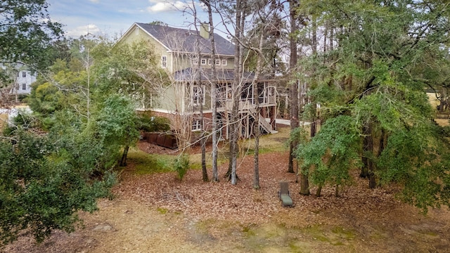 rear view of house featuring stairs