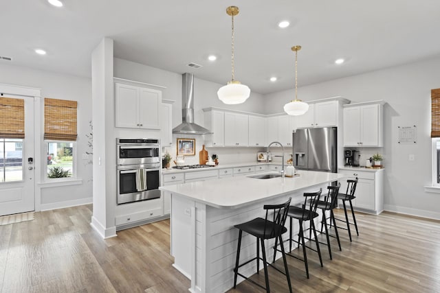109 Medford St, Summerville, SC 29486 - kitchen featuring stainless steel appliances, a sink, wall chimney range hood, recessed lighting, and light countertops