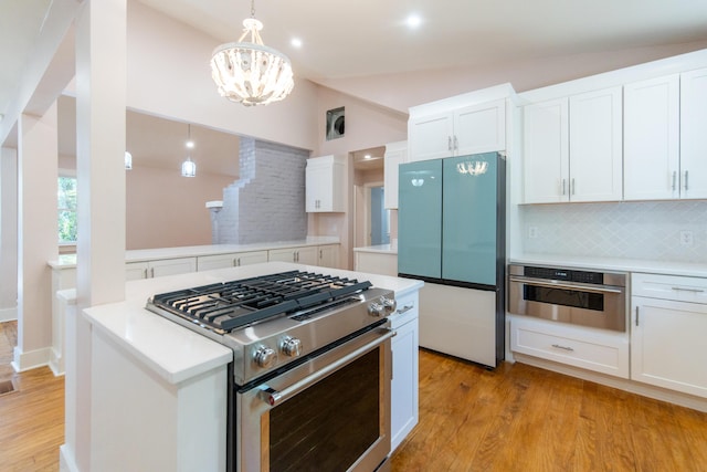 708 S Laurel St, Summerville, SC 29483 - kitchen with light countertops, backsplash, white cabinetry, light wood-style floors, and stainless steel appliances